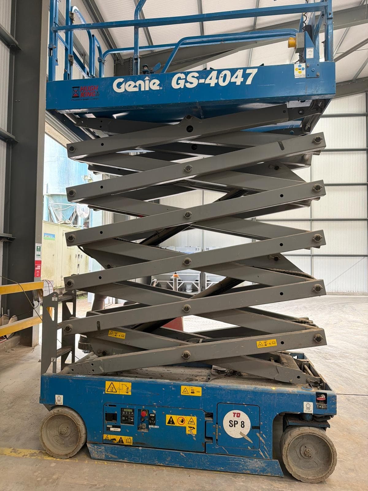 Scissor lift ready for inspection in a warehouse